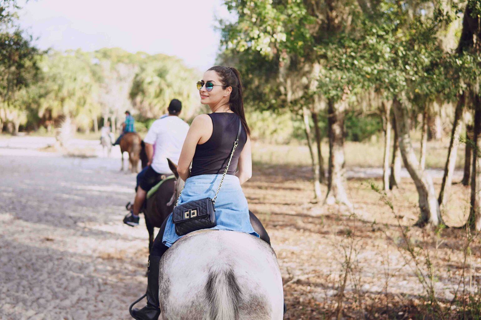 Woman on a horseback. Rider in a black uniform